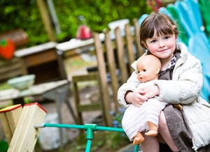 A pre-school student smiles at the camera at Highfield Pre-School.