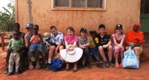 Highfield pupils with a Ugandan family outisde their home