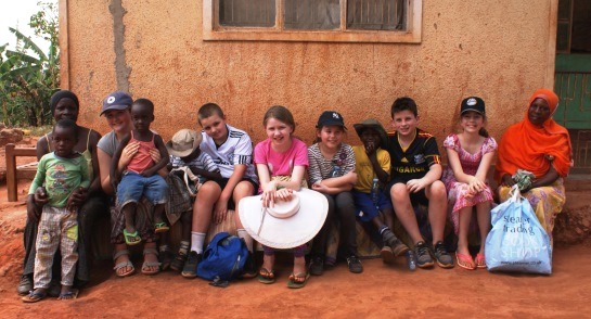 Highfield pupils with a Ugandan family outisde their home