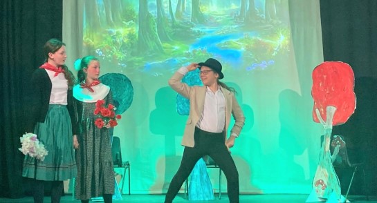 Drama pupils perform their version of Little Red Riding Hood against a wood backdrop for the Harrogate Ladies' College Junior House Drama Competition