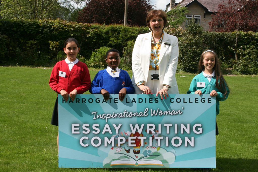 Harrogate Ladies' College Principal, Sylvia Brett celebrates with the Year 3, 4 and 5 winners of the Inspirational Woman Essay Writing Competition on the school lawn