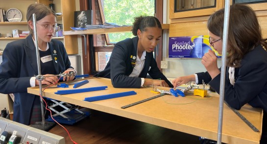 Three Lower 4 students from Harrogate Ladies' College complete a practical science challenge at the Physics Olympics