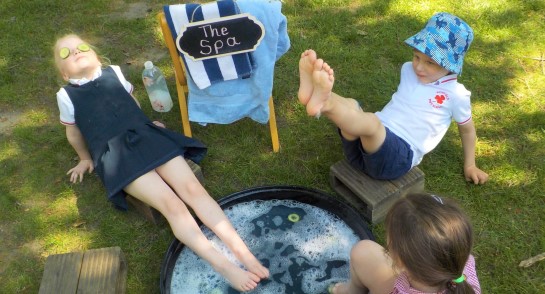 Transition children at Highfield Pre-School put their feet up in their garden 'spa'