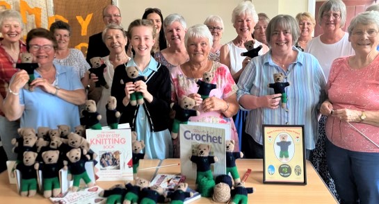 Members of Ripon Community Poppy Project and pupils and staff from Highfield Prep School gather in a group to showcase the hand-knitted teddies to be gifted to new Reception children at the school