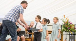 Pupils are presented with prizes by special guest, James McKay at the Highfield Prep School Speech Day and Prize Giving 2023