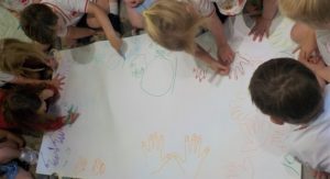 Transition pupils from Highfield Pre-School draw round their hands to create a collage as they develop their counting and numbers skills