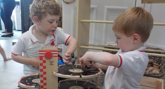 Pre school children playing with Dinosaurs