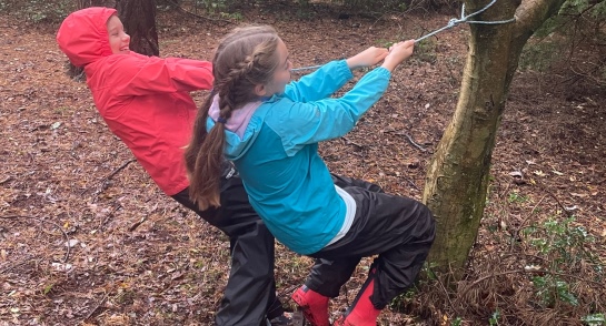Prep 6 girls swinging from a tree as part of their forest school session