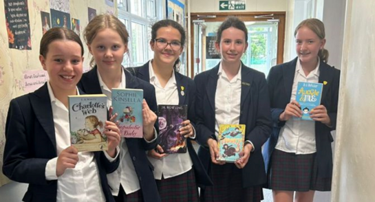 Harrogate Ladies' College pupils holding up books